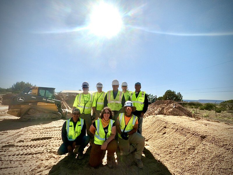 Group shot of IWSH volunteers posing in front of a new septic system installed on the Navajo Nation