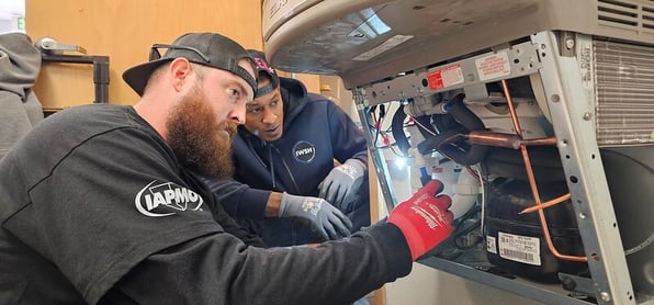 Plumbers installing a product