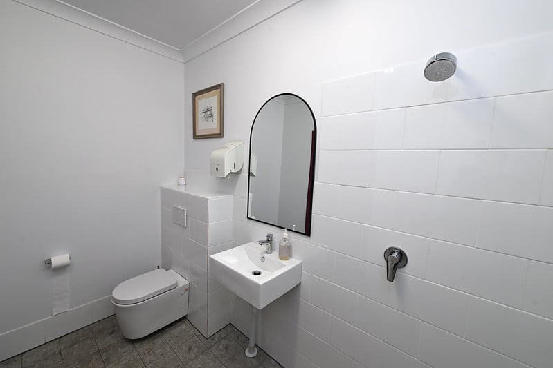 Retrofitted white bathrom at the at the ADRA Logan Community Care Centre