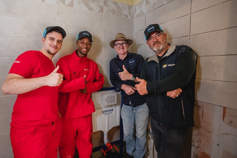 Four IWSH plumbers giving thumbs up 